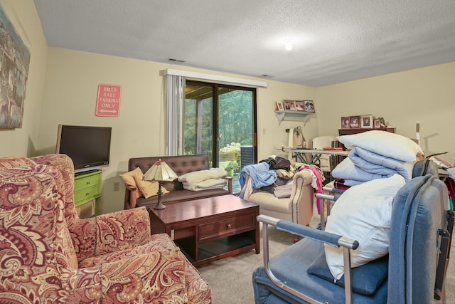 interior space with access to exterior, visible vents, and a textured ceiling