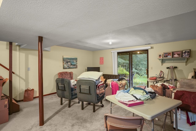 carpeted dining area with a textured ceiling and baseboards