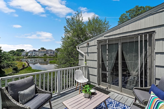 wooden deck featuring a water view