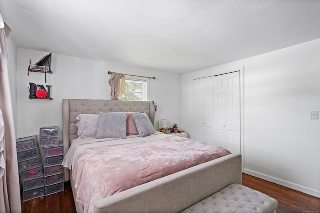 bedroom featuring a closet, baseboards, and wood finished floors