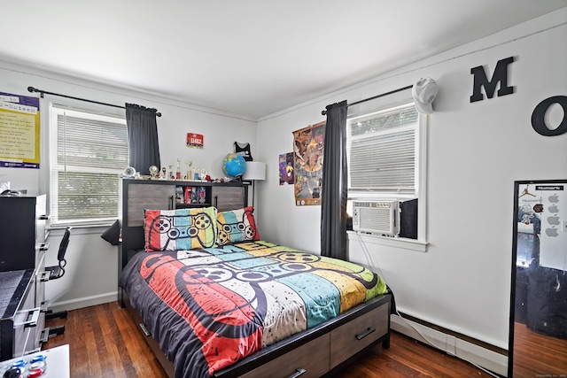 bedroom featuring cooling unit, a baseboard heating unit, baseboards, and wood finished floors