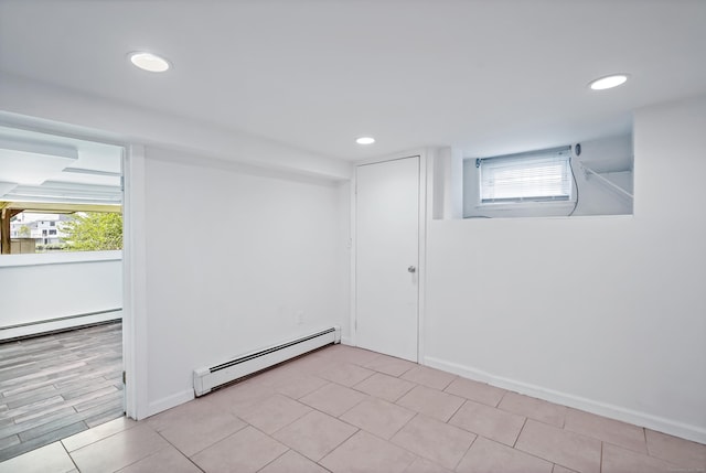 empty room with recessed lighting, a baseboard heating unit, and baseboards