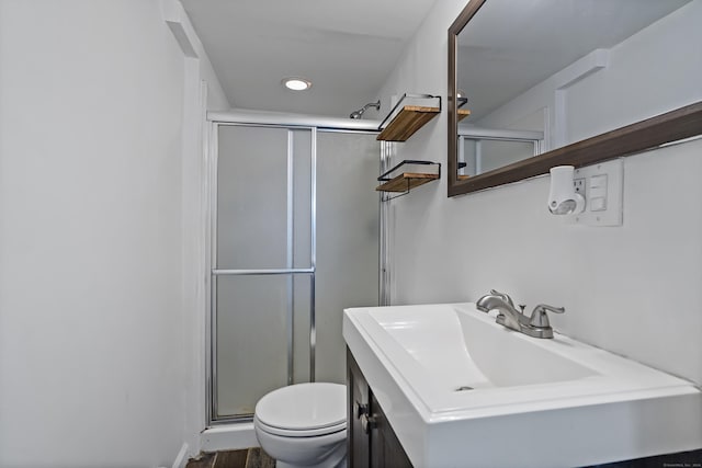 full bath featuring recessed lighting, toilet, a stall shower, and vanity