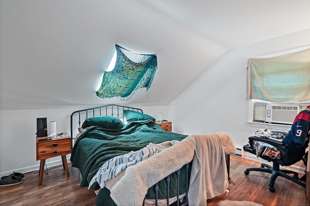 bedroom with lofted ceiling, wood finished floors, and baseboards