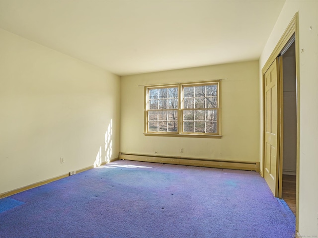 unfurnished bedroom featuring a baseboard heating unit and carpet flooring