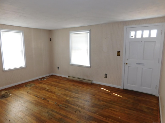 foyer featuring hardwood / wood-style flooring, baseboards, and a baseboard radiator