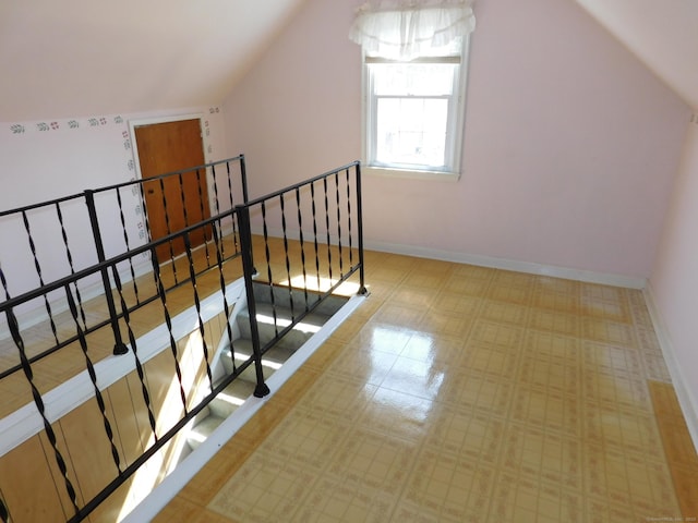 interior space with baseboards and lofted ceiling