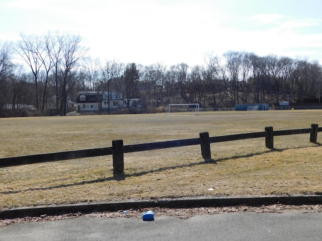 view of yard featuring a rural view and fence