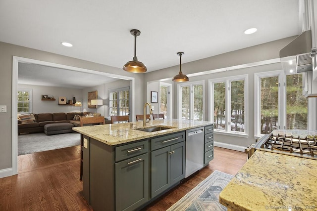 kitchen featuring a sink, dishwasher, pendant lighting, dark wood-style flooring, and a kitchen island with sink