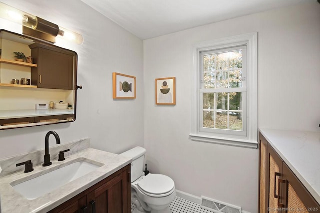 bathroom with visible vents, baseboards, toilet, and vanity