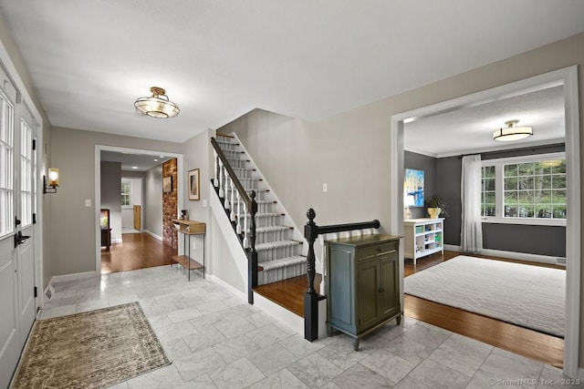 entryway featuring stairway and baseboards