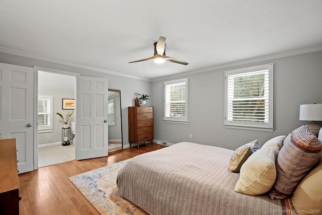 bedroom featuring hardwood / wood-style floors, crown molding, a ceiling fan, and baseboards