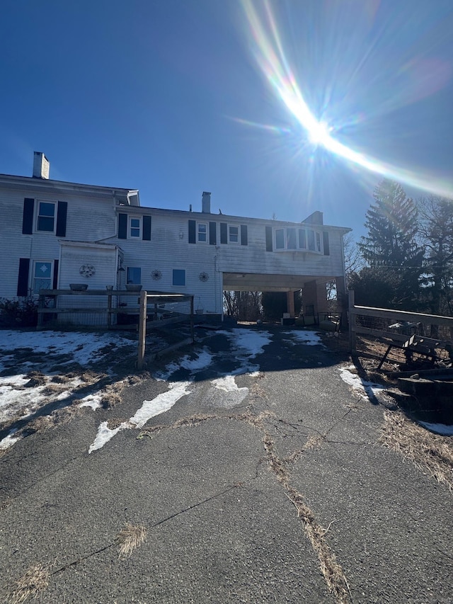 view of front of home with driveway and a chimney