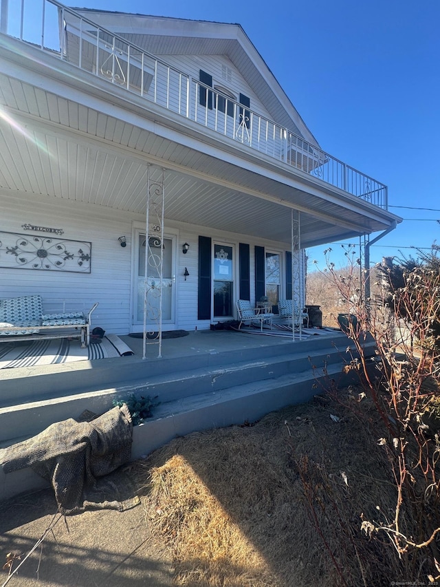 exterior space featuring a balcony and a porch