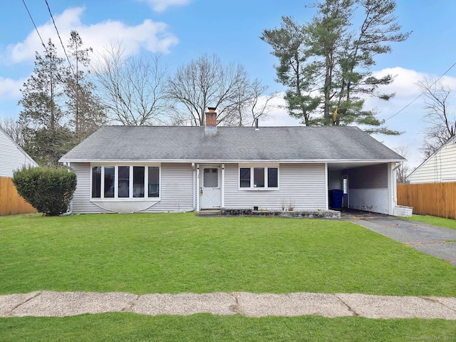 single story home featuring an attached carport, fence, roof with shingles, a front lawn, and aphalt driveway