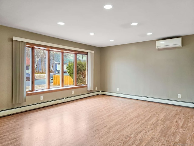 spare room featuring recessed lighting, a baseboard heating unit, wood finished floors, and a wall unit AC