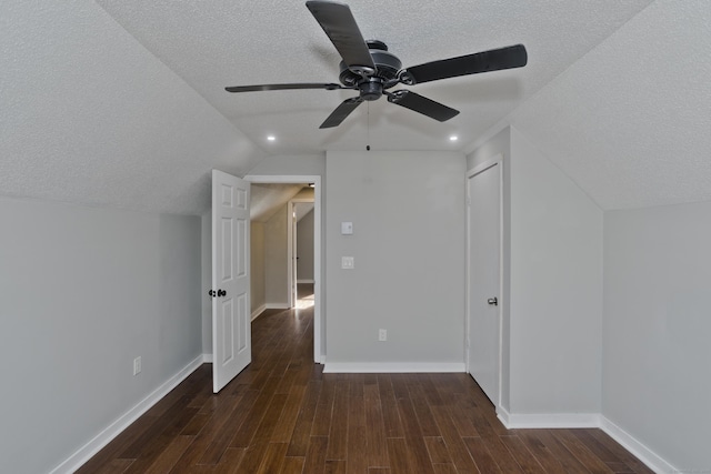 bonus room with baseboards, lofted ceiling, a textured ceiling, and wood finished floors