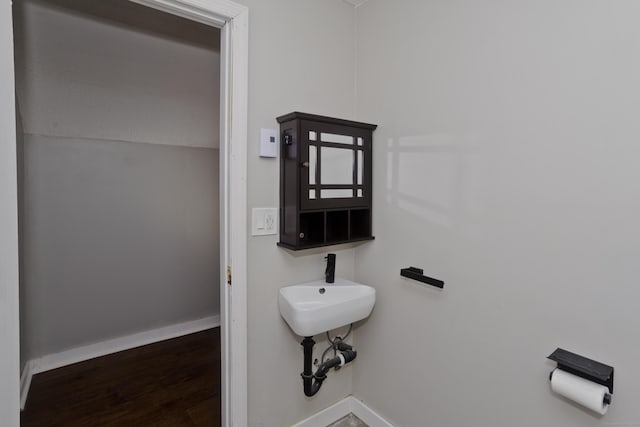 bathroom with baseboards and wood finished floors