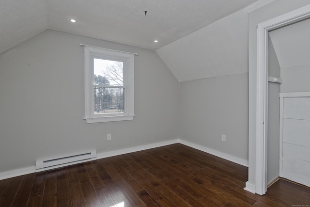 additional living space with a baseboard radiator, lofted ceiling, baseboards, and hardwood / wood-style floors