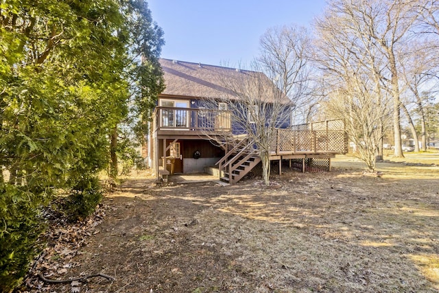 back of property featuring stairs and a wooden deck