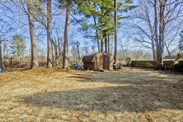 view of yard with a storage shed, fence, and an outdoor structure