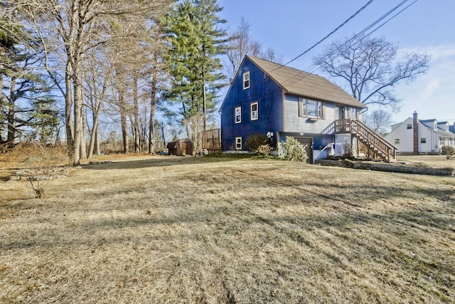 view of side of home featuring stairway