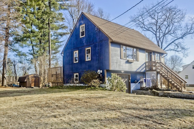 view of front of home featuring stairs, a front lawn, roof with shingles, and an attached garage