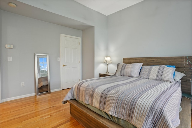 bedroom with baseboards and light wood-style floors