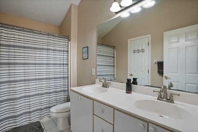 bathroom featuring a sink, toilet, double vanity, and tile patterned floors