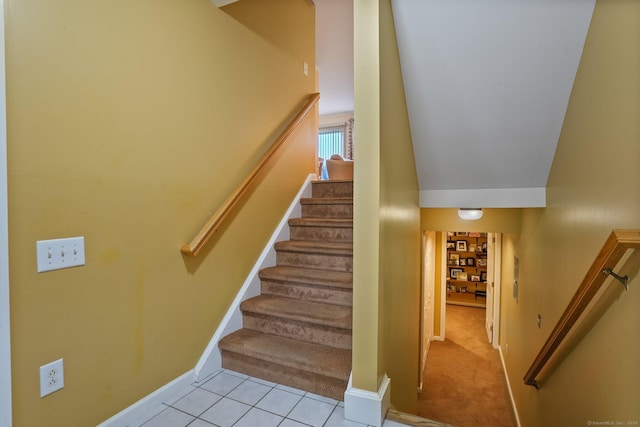 stairs with tile patterned floors, carpet flooring, and baseboards