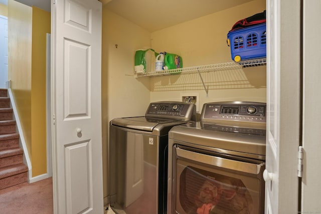 laundry area featuring baseboards, carpet, laundry area, and washing machine and clothes dryer