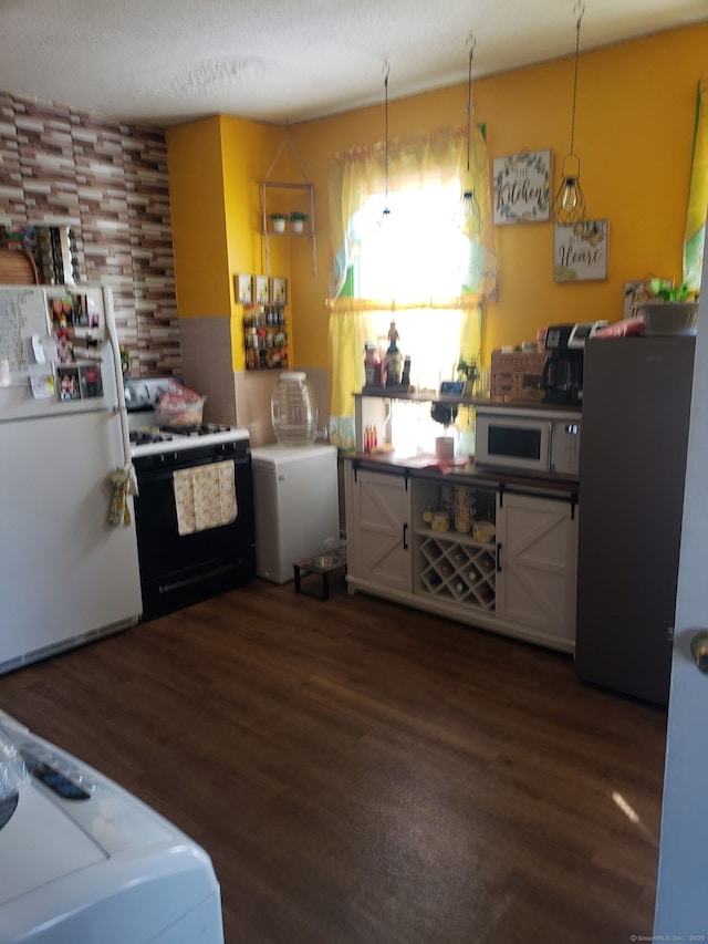 kitchen featuring white appliances and wood finished floors