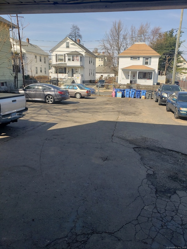 uncovered parking lot featuring a residential view