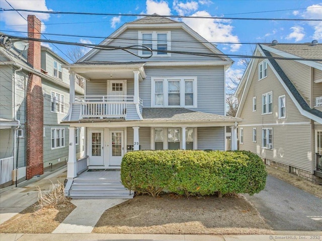 view of front of home with a porch and a balcony