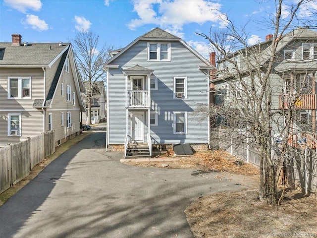 view of front of home featuring driveway and fence