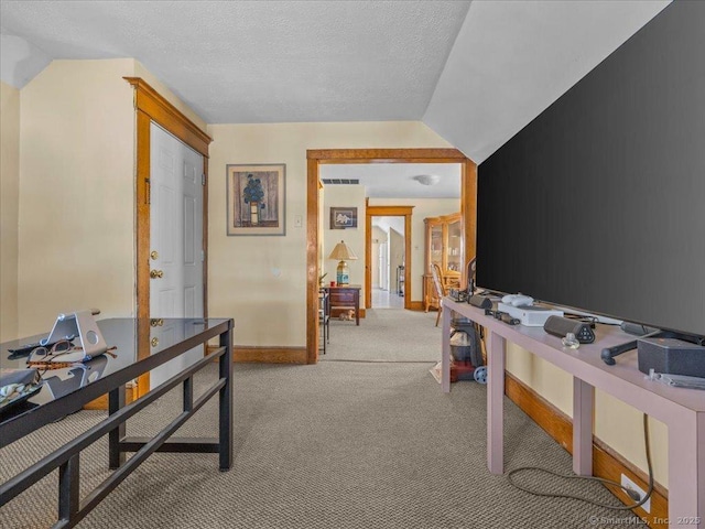 office area with light carpet, a textured ceiling, baseboards, and vaulted ceiling