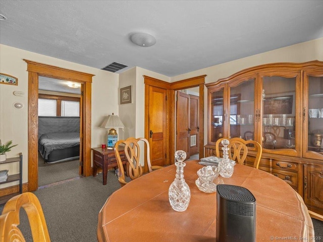 dining area featuring visible vents and carpet floors