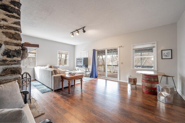 20 Musnug Rd, Danbury, CT 06811 - living room featuring rail lighting, a textured ceiling, baseboards, and hardwood / wood-style floors