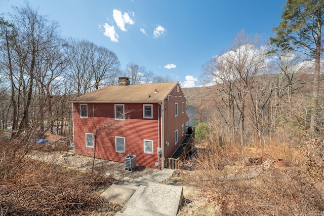 20 Musnug Rd, Danbury, CT 06811 - back of property with roof with shingles, a chimney, and central AC