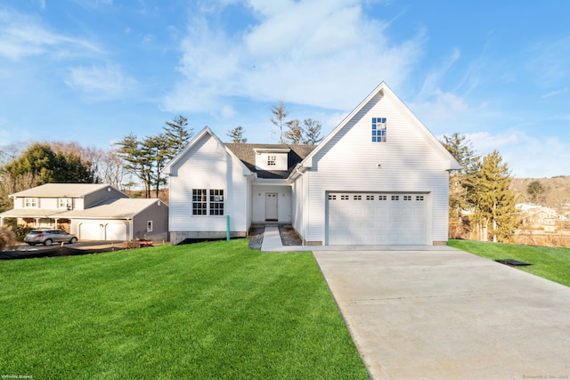 view of front of home with an attached garage, driveway, and a front lawn