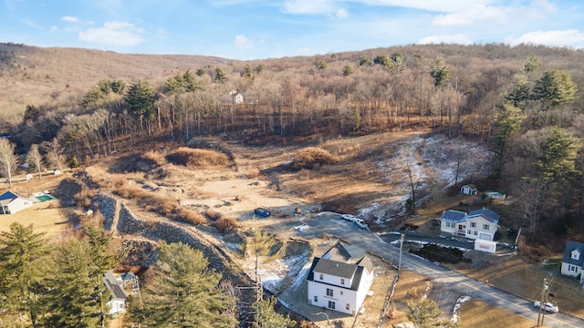 birds eye view of property with a view of trees