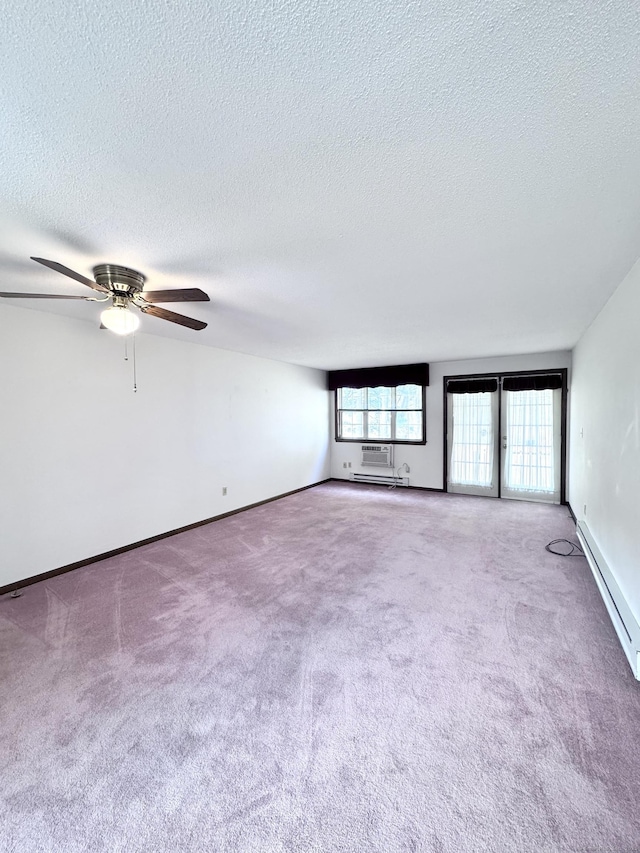 unfurnished room featuring baseboards, carpet, a ceiling fan, and a textured ceiling