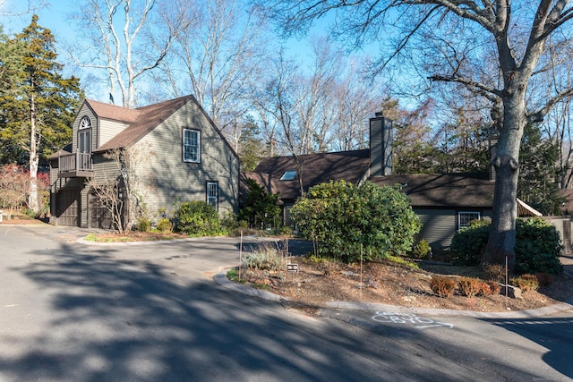 view of home's exterior with stairs and a chimney