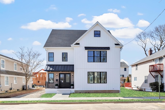 back of house featuring french doors, metal roof, a shingled roof, and a standing seam roof