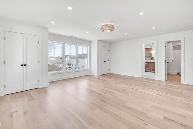 interior space with recessed lighting, baseboards, and light wood finished floors