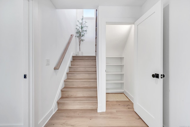 stairs with wood finished floors