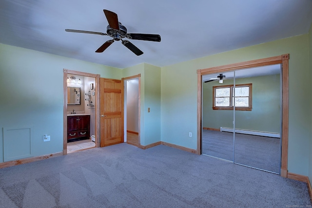 unfurnished bedroom featuring carpet flooring, ensuite bathroom, baseboards, and a baseboard radiator