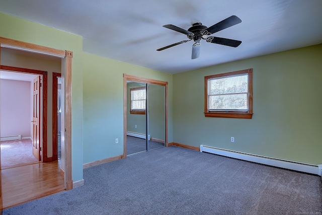 unfurnished bedroom with carpet floors and a baseboard radiator