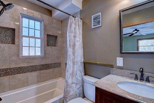 bathroom with visible vents, ceiling fan, toilet, vanity, and shower / bathtub combination with curtain