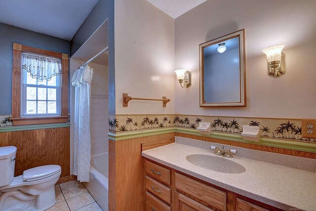 full bath featuring toilet, shower / bath combination with curtain, vanity, and tile patterned flooring